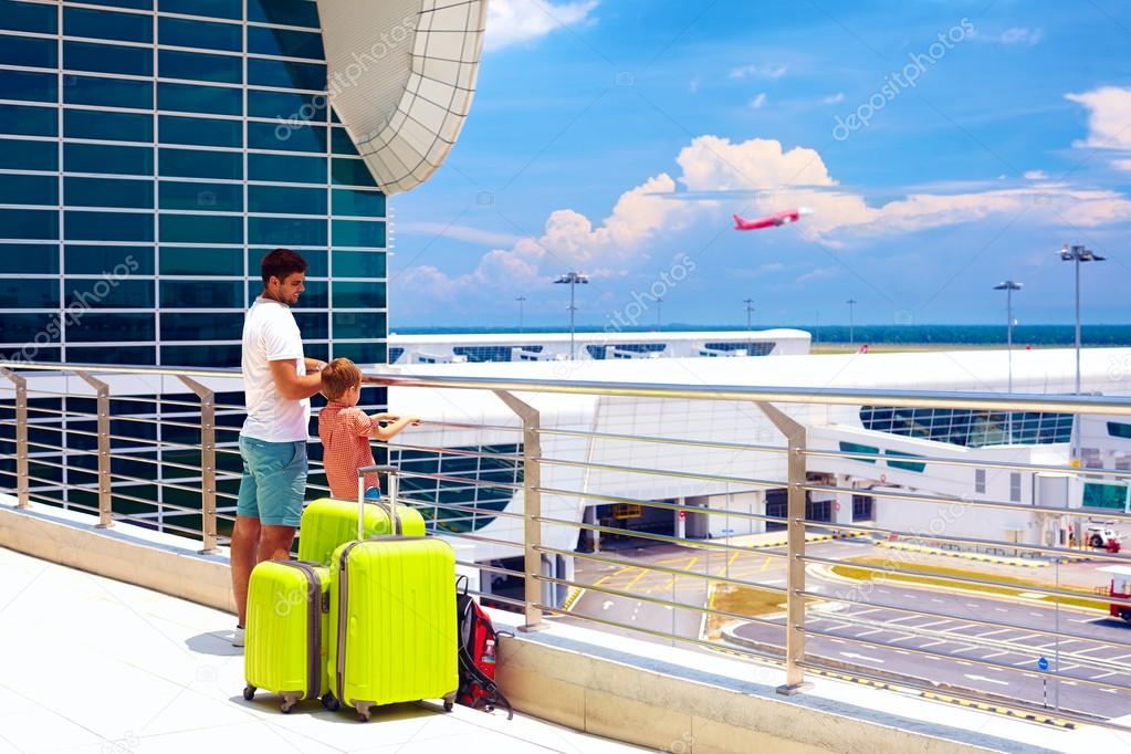 father and son ready for summer vacation, while waiting for boarding in international airport