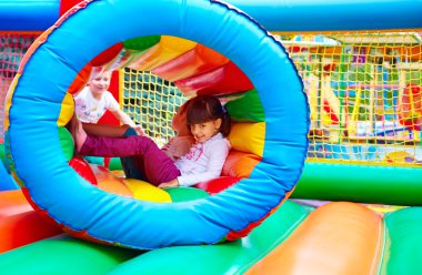 happy kids, having fun on inflatable attraction playground