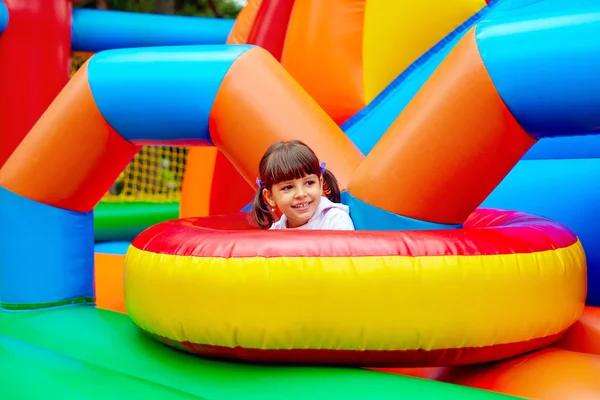 Happy kid, having fun on inflatable attraction playground — Stockfoto