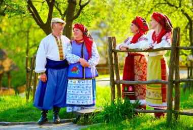 happy ukrainian family, dressed in national costumes, talking on the street