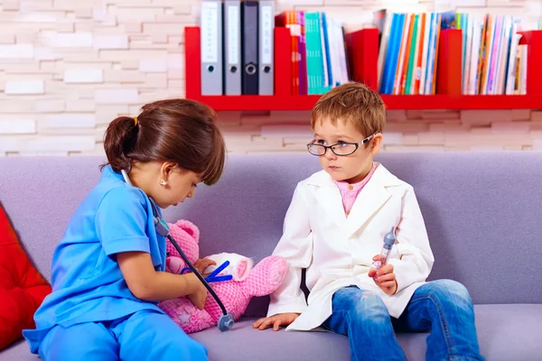 Cute kids playing in doctors with toy instruments — Stok fotoğraf