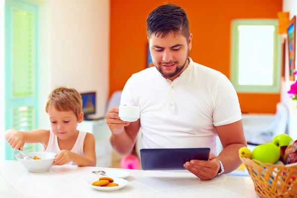 Father and son having breakfast in the morning at home kitchen — Stock Photo, Image