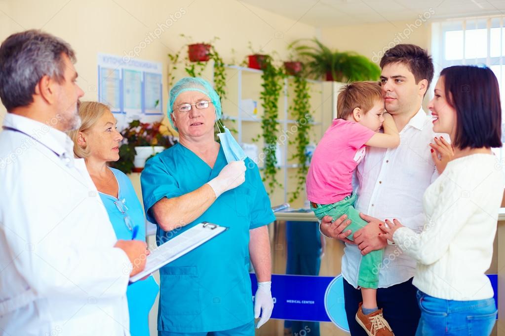 exhausted medical staff announcing good news to relatives after long and difficult surgery