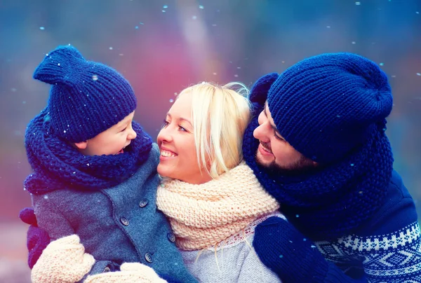 Familia feliz divirtiéndose juntos bajo nieve de invierno — Foto de Stock