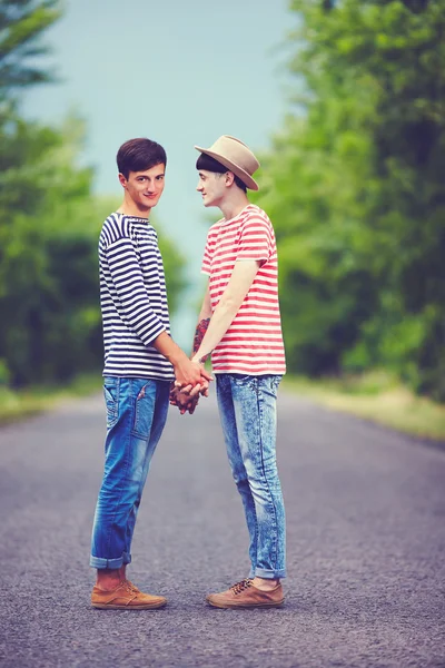 Happy gay couple together on spring road — Stock Photo, Image