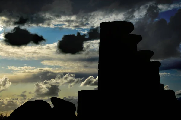Silhouette of the Temple of Hercules under a moody sky. At the Valley of the Temples, Agrigento, Sicily
