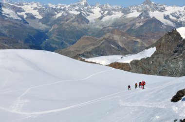 Approaching the summit, a team of climbers clipart
