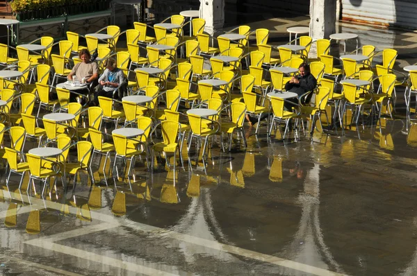 Venice sinking beneath the sea, with people in chairs — Stock Photo, Image