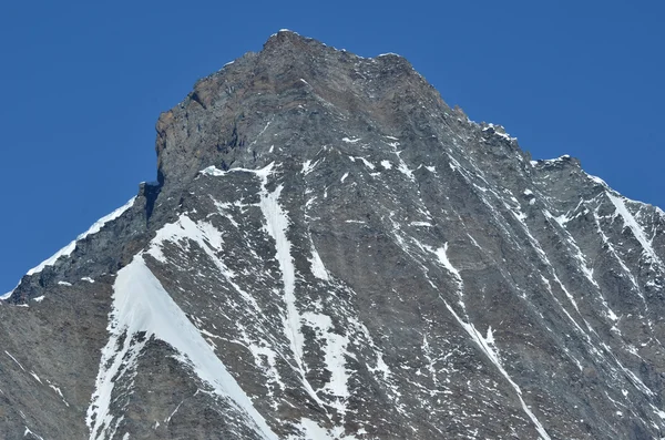 Snötäckta berg mot blå himmel — Stockfoto