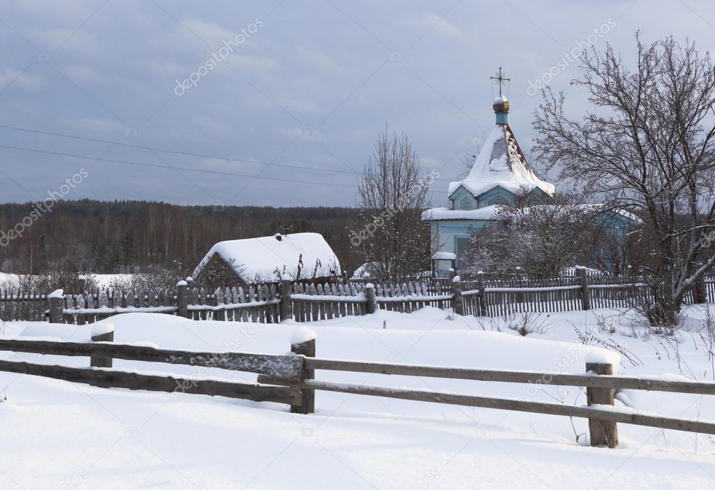 Rustic, winter landscape with a chapel. Chapel of Our Lady of Tikhvin. Village Klopovskaya (Mishin), Velsky District, Arkhangelsk region, Russia