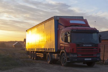 Village Street and Scania commercial vehicle in the setting sun