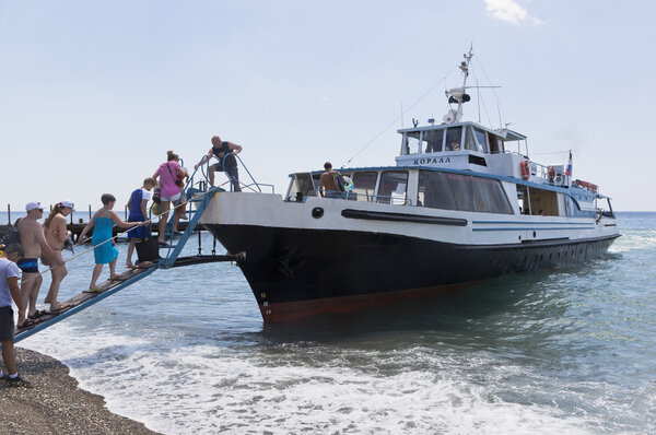 Passengers boarding from the beach resort village Praskoveevka on the ship Coral. Gelendzhik, Krasnodar region, Russia