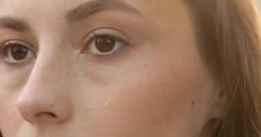 Siyah saçlı güzel bir bayanın kameraya keskin bir bakışla bakışıyla. Güzel bir kadın yüzünün parçası. Kahverengi gözlere odaklan.