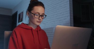 Uzaktan kumanda için modern dizüstü bilgisayar kullanan odaklı kadın