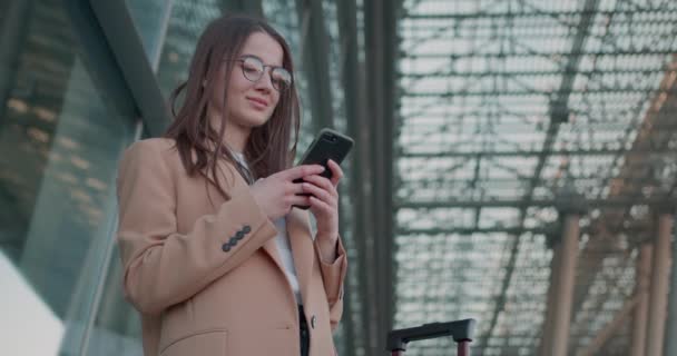 Charmante Femme Affaires Lunettes Avec Valise Smartphone Debout Près Aéroport — Video