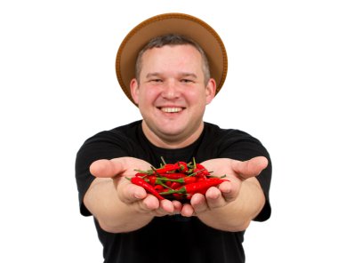 Young fat man with chili in his hands. clipart