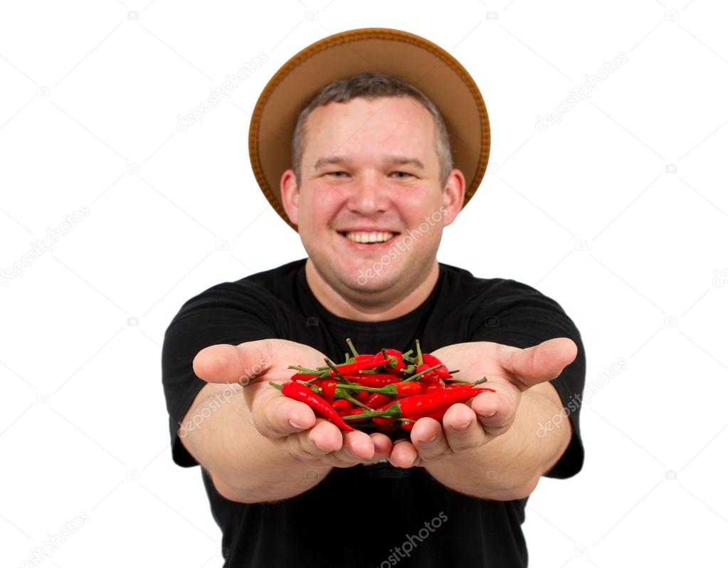 Young fat man with chili in his hands.