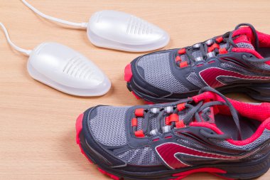 Electric ultraviolet shoe dryer and Sneakers. clipart