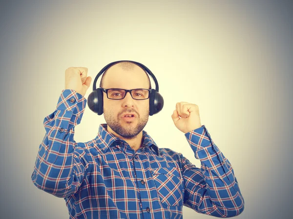 Men in headphones listens to music and sings. Stock Picture