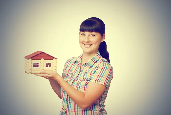 Young woman holding home — Stock Photo, Image