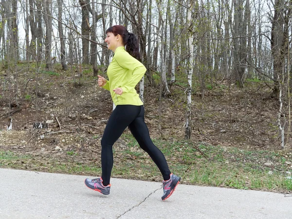 Young woman running in nature.