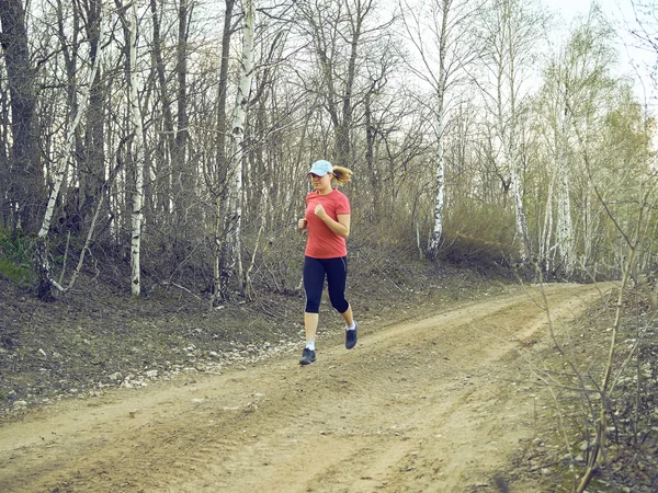 beautiful young woman running in forest.