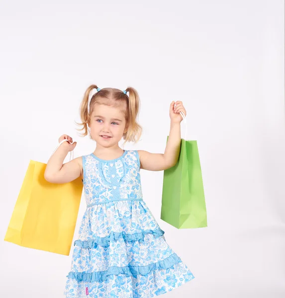 Niño de compras. niña sosteniendo bolsas de compras —  Fotos de Stock
