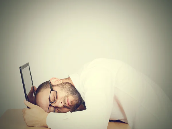 Portrait  of tired businessman sleeping on his laptop Stock Image