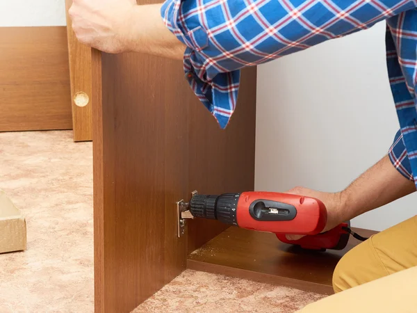 Man collects furniture. — Stock Photo, Image