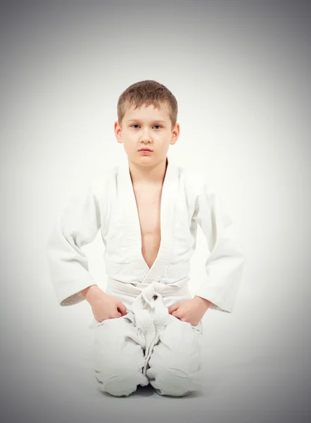 Karate boy in white kimono fighting — Stock Photo, Image