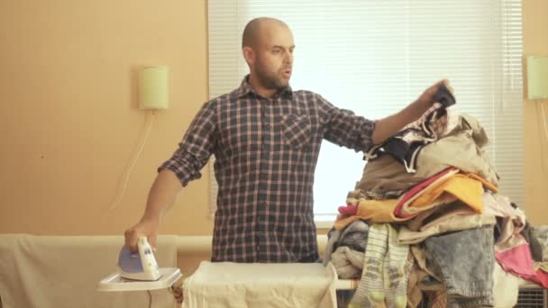 Caucasian man ironed clothes in the room near the window. Homework. — Stock Footage Caucasian man ironed clothes in the room near the window. Homework. Royalty Free Stock Footage