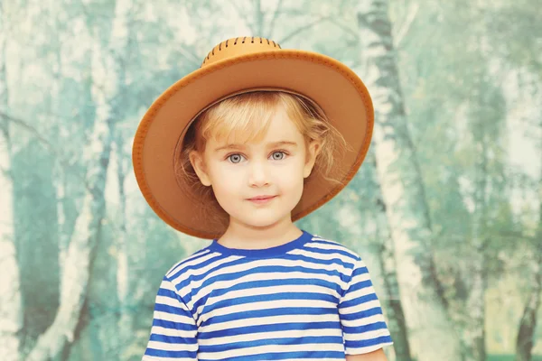 Little girl playing in cowboy — Stock Photo, Image