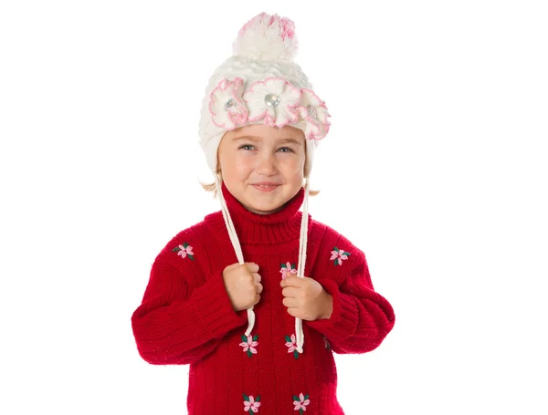 Niña con colas de caballo en un sombrero caliente y suéter rojo en una w — Foto de Stock