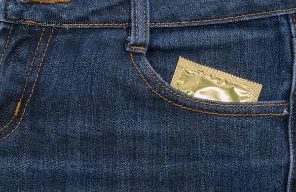 Condom in jeans pocket.  background. — Stock Photo, Image