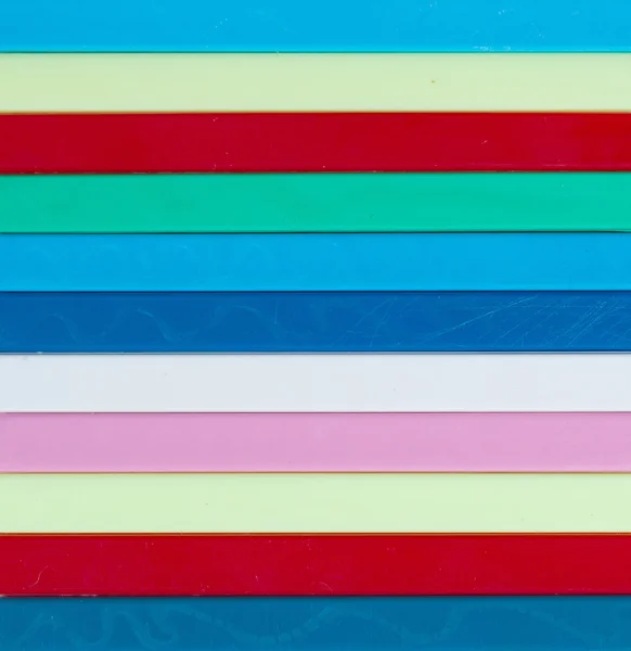 Colorful striped background. Plastique sticks of different color — Stock Photo, Image