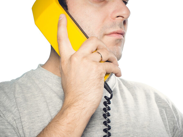 Caucasian man talking on a landline phone.