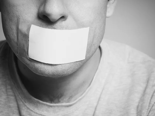 Caucasian man with duct tape on mouth, white . — Stock Photo, Image