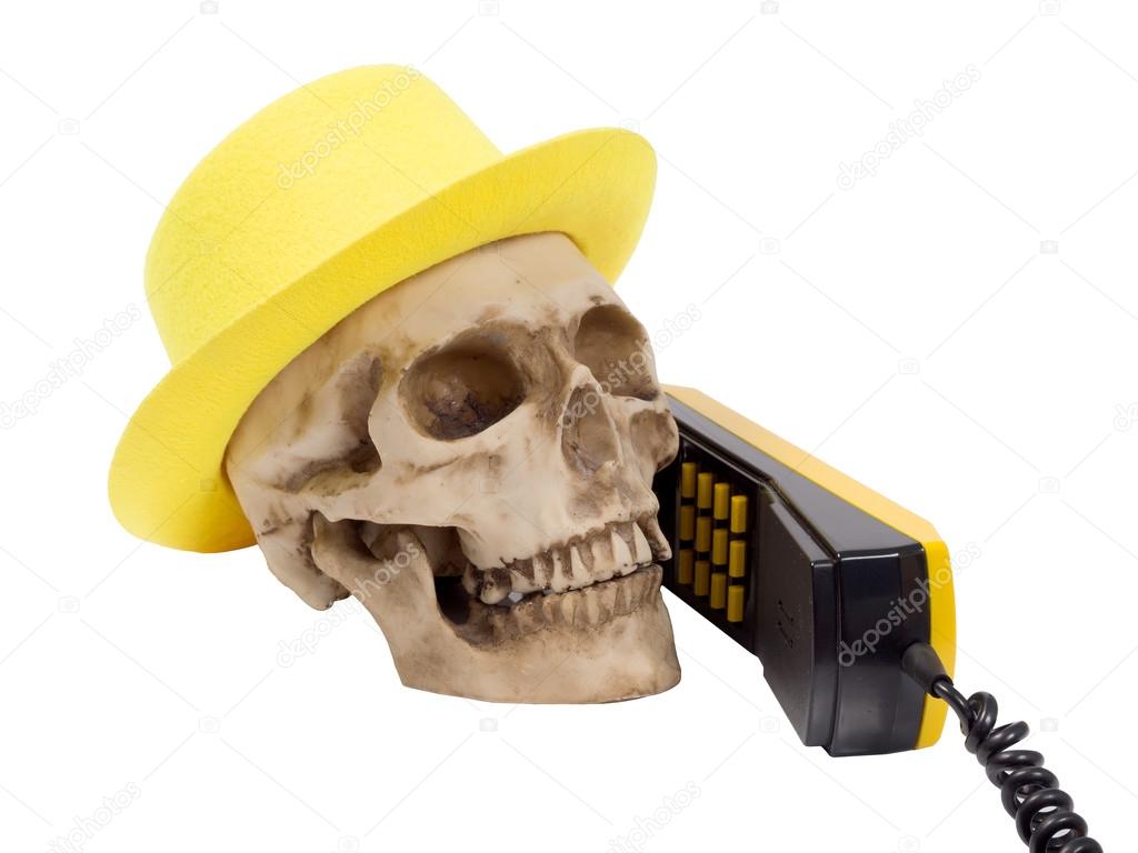Skull in yellow hat on phone