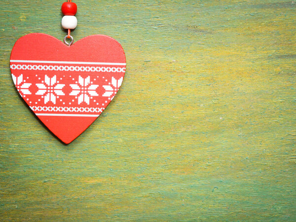 Red heart on wooden background.