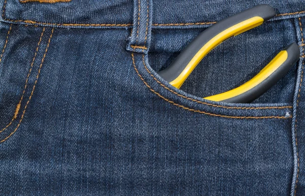 ジーンズのポケットに黄色のハンドル付けプライヤー。バック グラウンド. — ストック写真