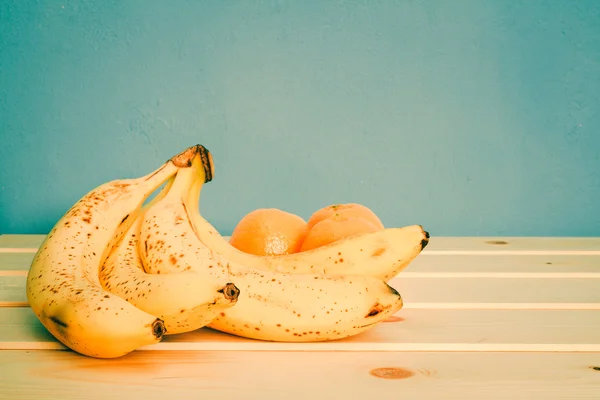 Bananas, mandarines on wooden table — Stock Photo, Image