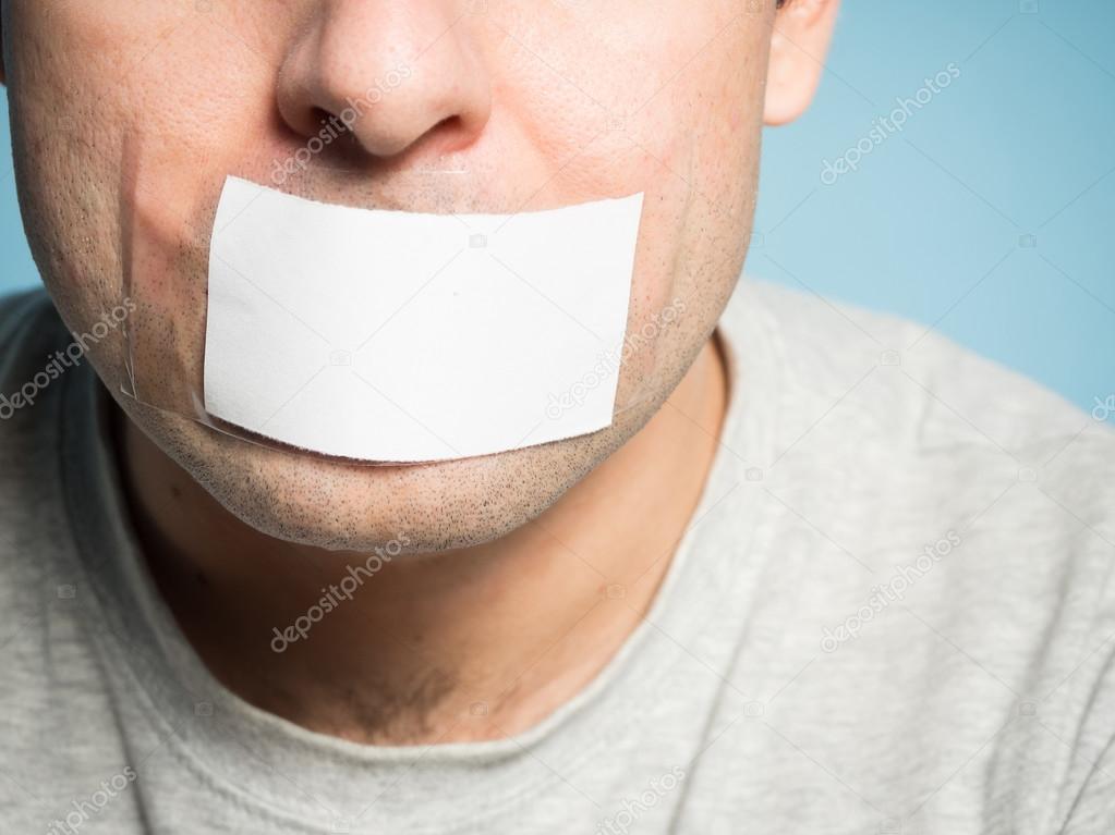 Caucasian man with duct tape on mouth, white .