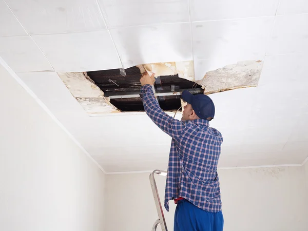 Man Repairing Collapsed Ceiling, How To Fix A Collapsed Ceiling