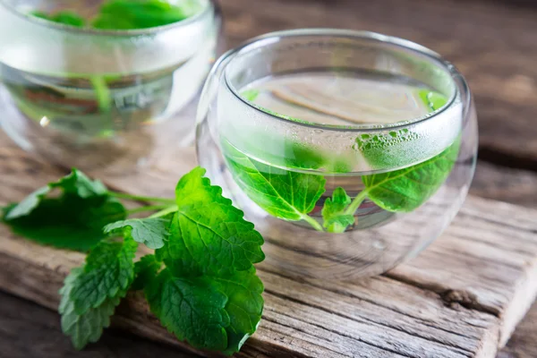 Tea with mint on a wooden table — Stock Photo, Image