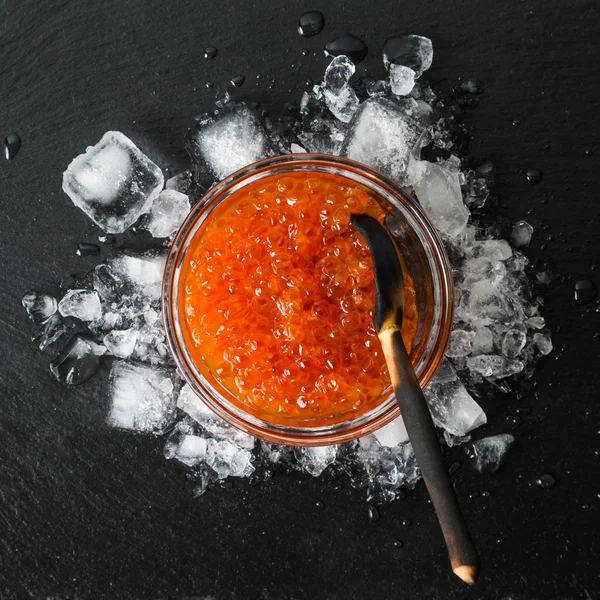 Salted red caviar on ice