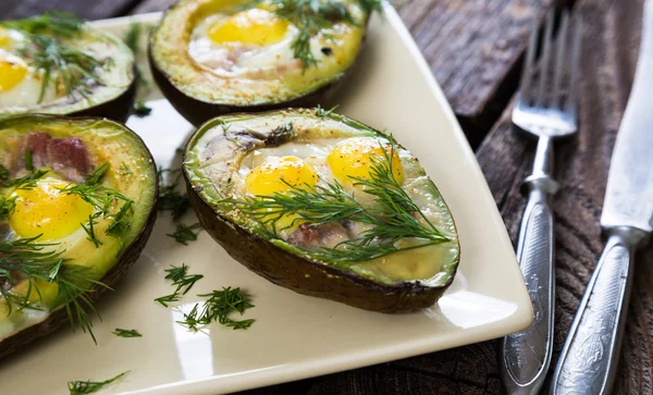 Baked avocado with eggs and bacon — Stock Photo, Image