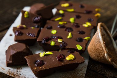 Homemade chocolate with dried berries and pistachios clipart