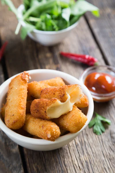 Fried cheese sticks on table