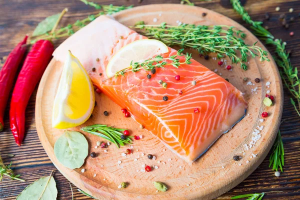 A piece of salmon and spices — Stock Photo, Image