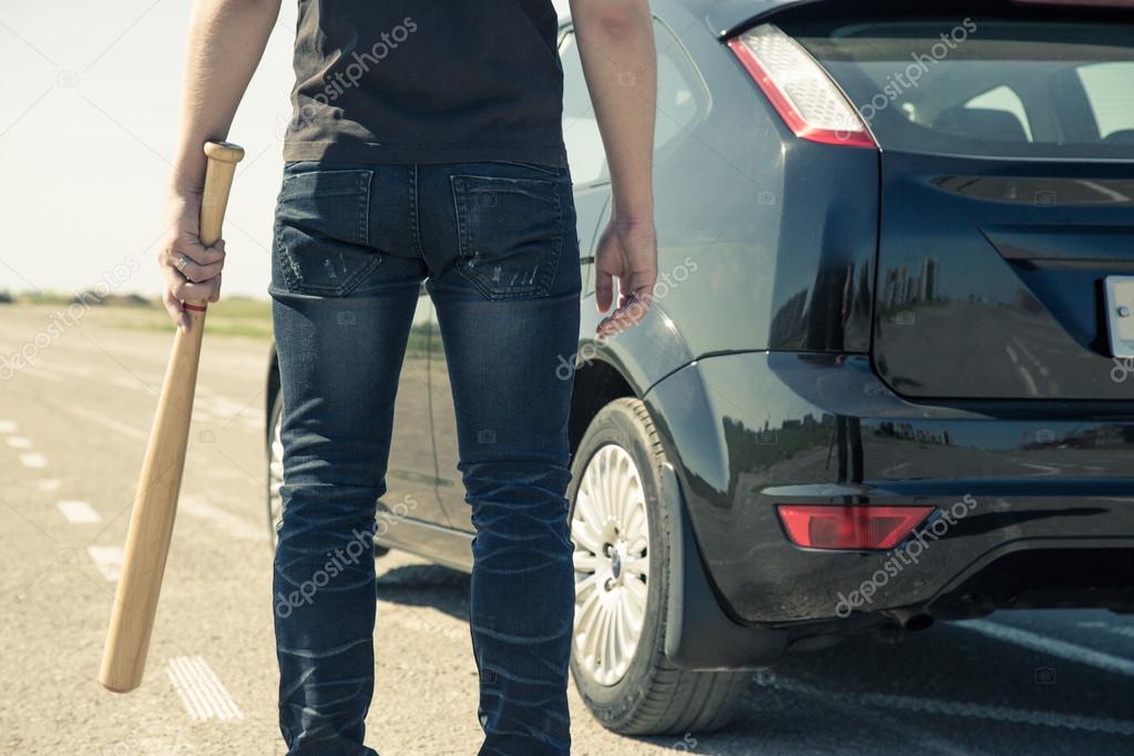 Man with baseball bat on the road before the car Stock Photo by ©rus7
